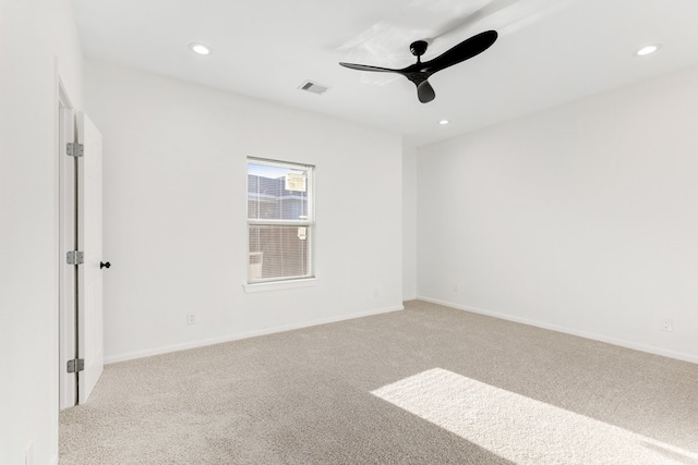 empty room featuring visible vents, light carpet, a ceiling fan, recessed lighting, and baseboards