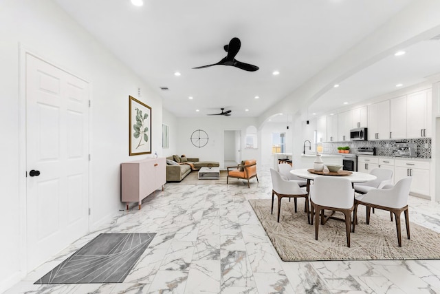 dining space with a ceiling fan, visible vents, recessed lighting, arched walkways, and marble finish floor