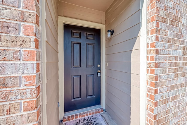 entrance to property with brick siding