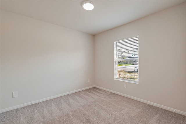 empty room with light carpet and baseboards