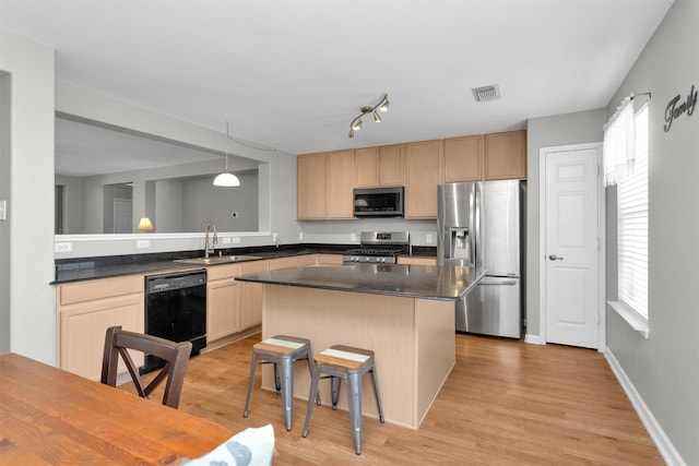 kitchen with a wealth of natural light, visible vents, stainless steel appliances, and a sink