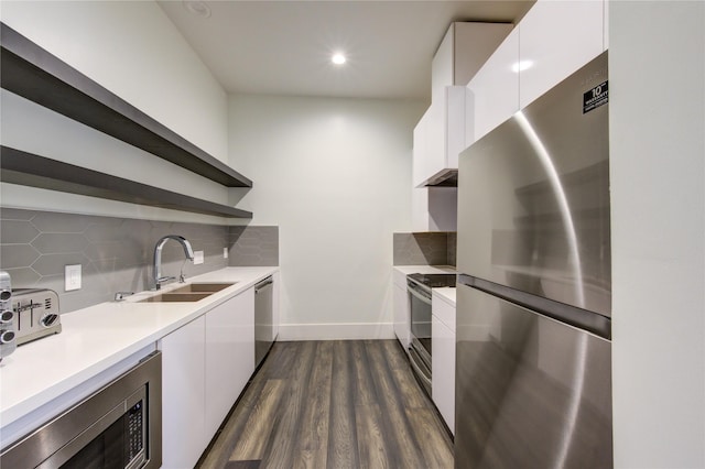 kitchen with stainless steel appliances, white cabinetry, a sink, and open shelves