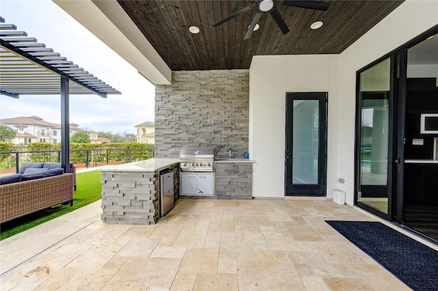 view of patio / terrace with exterior kitchen, ceiling fan, area for grilling, and fence