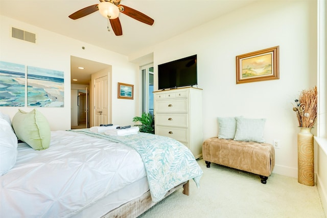 bedroom featuring baseboards, visible vents, a ceiling fan, and light colored carpet