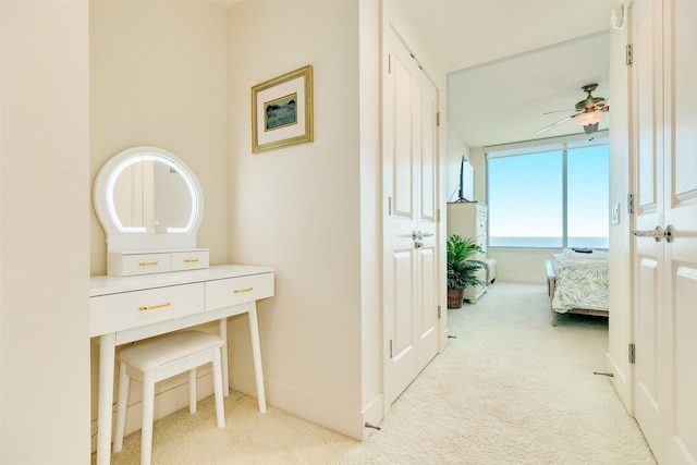 hallway with carpet floors and baseboards