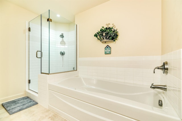 bathroom with a stall shower, tile patterned flooring, and a bath