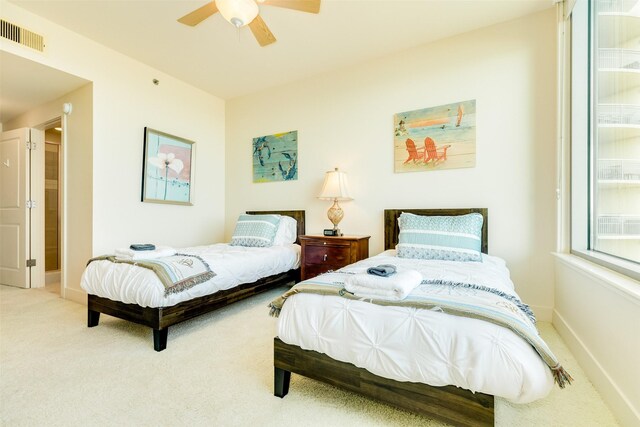 bedroom with ceiling fan, carpet floors, visible vents, and baseboards