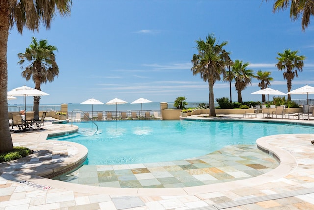 pool with a patio area and fence