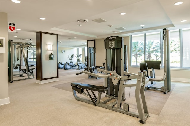 exercise room with recessed lighting, light colored carpet, and visible vents