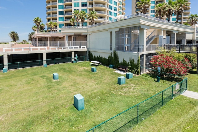 view of community with fence and a lawn