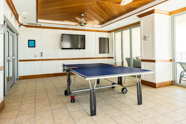 recreation room featuring light tile patterned floors, ceiling fan, visible vents, wood ceiling, and a tray ceiling