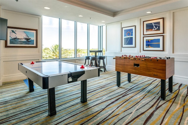 game room with crown molding, recessed lighting, and a decorative wall