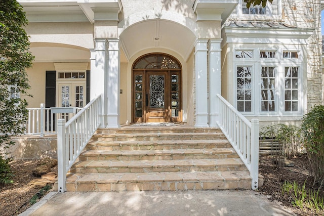 doorway to property with stucco siding