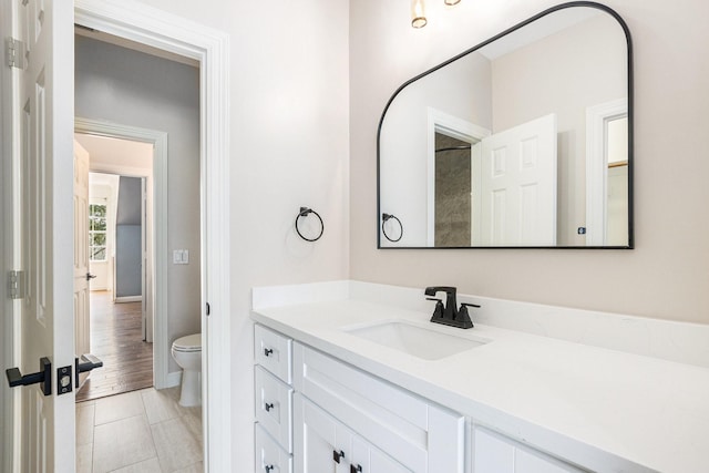 bathroom featuring vanity and toilet