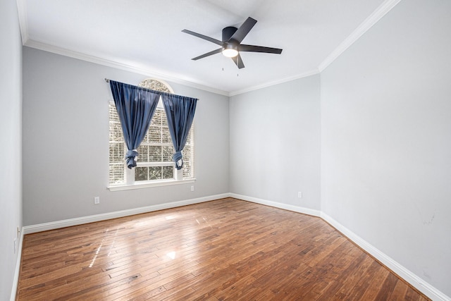 unfurnished room featuring wood-type flooring, ornamental molding, ceiling fan, and baseboards