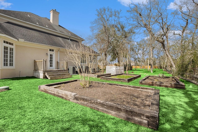 view of yard with fence and a vegetable garden