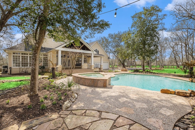 outdoor pool with an in ground hot tub, central AC unit, a patio, and a ceiling fan