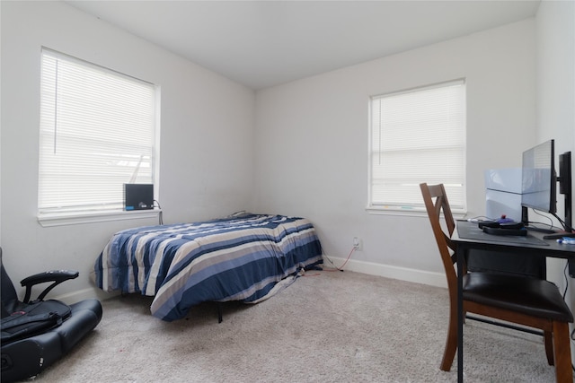 carpeted bedroom featuring baseboards