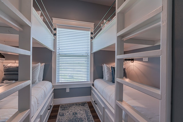 bedroom with dark wood-style floors and baseboards