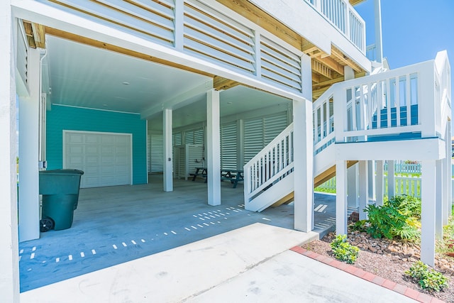 view of patio / terrace with stairs and a carport