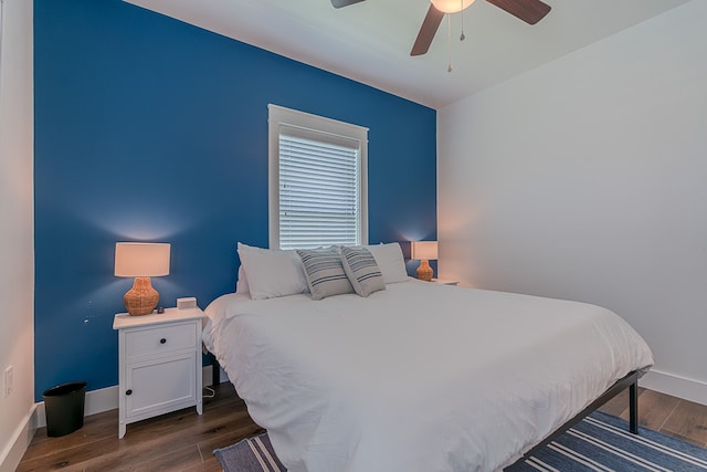 bedroom with ceiling fan, baseboards, and dark wood-style flooring