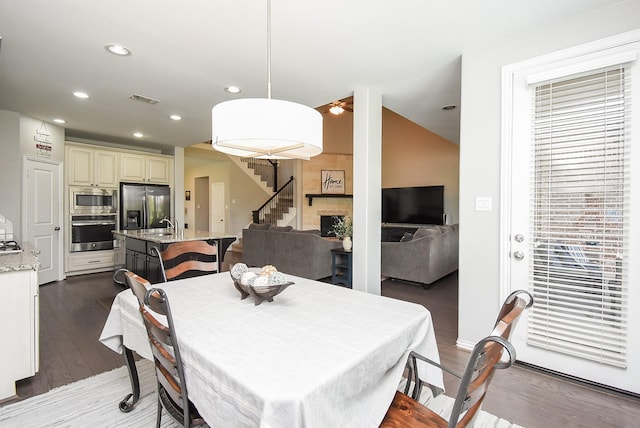 dining room featuring dark wood-style floors, stairway, visible vents, and recessed lighting