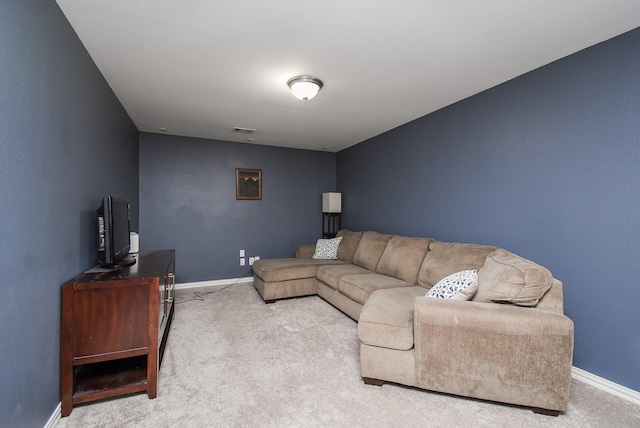 carpeted living area with visible vents and baseboards