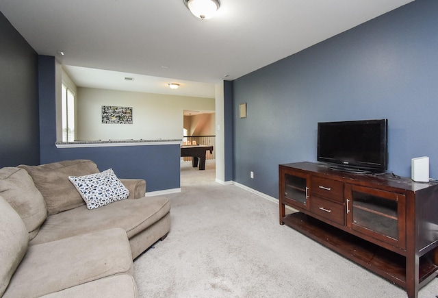 living room featuring carpet and baseboards