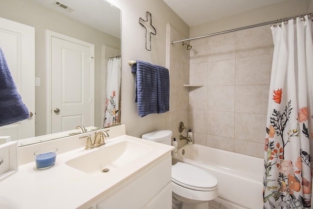 bathroom featuring visible vents, vanity, toilet, and shower / bath combo with shower curtain