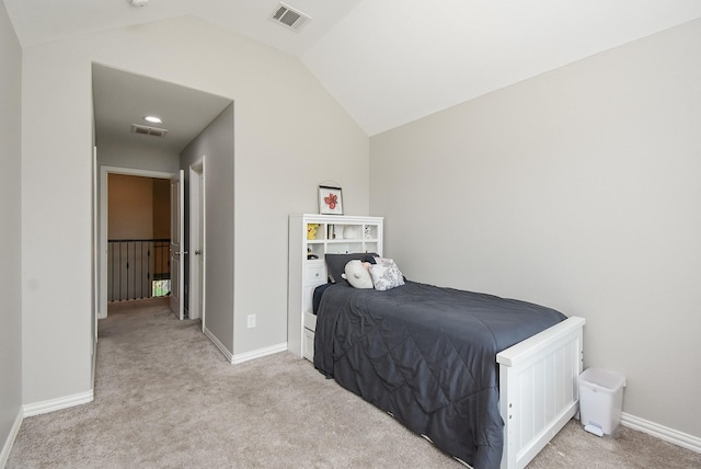 bedroom with lofted ceiling, visible vents, light carpet, and baseboards