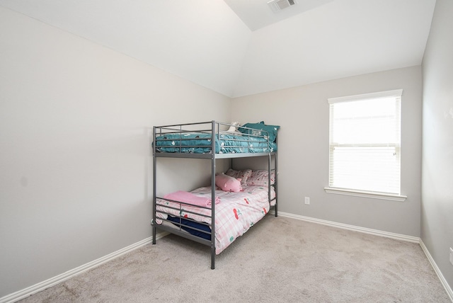 bedroom featuring carpet floors, baseboards, visible vents, and vaulted ceiling