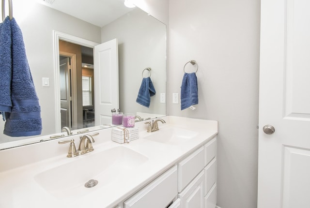 bathroom featuring double vanity and a sink