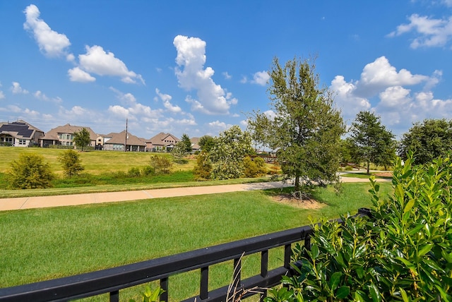 view of home's community featuring a residential view and a lawn