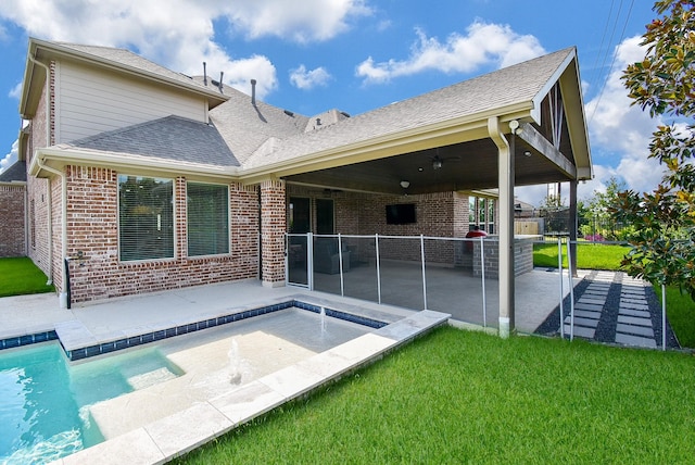 rear view of property with a patio area, ceiling fan, and brick siding