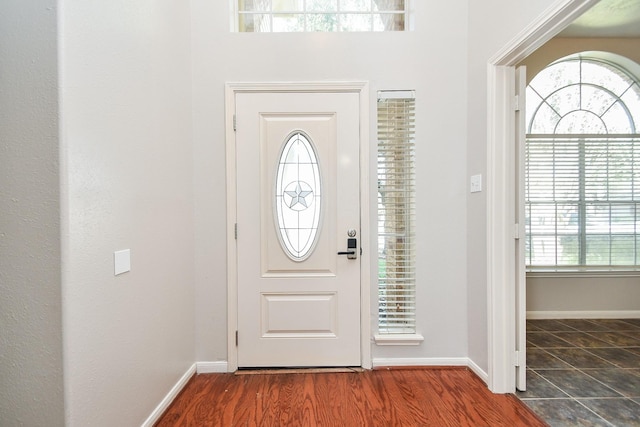 entryway with baseboards and wood finished floors