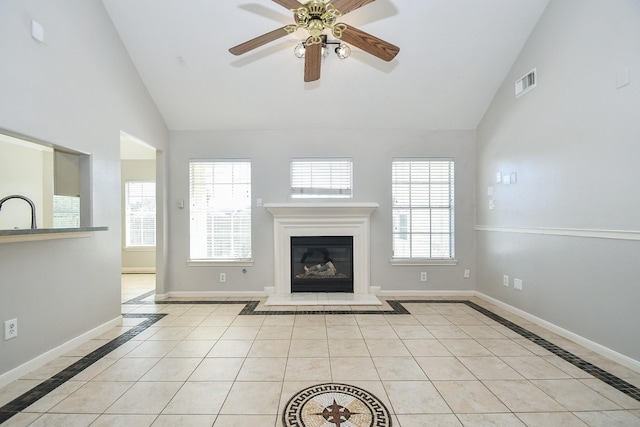 unfurnished living room featuring baseboards, light tile patterned flooring, visible vents, and a healthy amount of sunlight