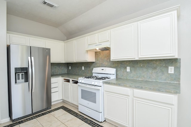 kitchen with stainless steel refrigerator with ice dispenser, white gas range, tasteful backsplash, visible vents, and under cabinet range hood