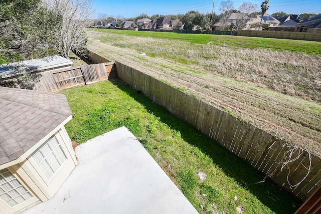 view of yard with a fenced backyard and a residential view