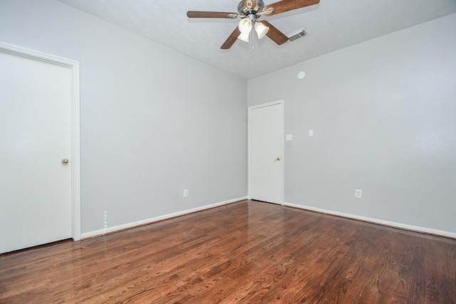 empty room with visible vents, ceiling fan, baseboards, and wood finished floors