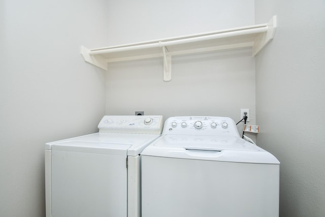 clothes washing area with laundry area and separate washer and dryer