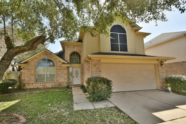 traditional-style home with a garage, concrete driveway, and brick siding