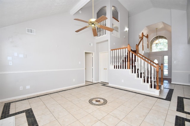 entryway with baseboards, visible vents, lofted ceiling with beams, stairway, and tile patterned floors