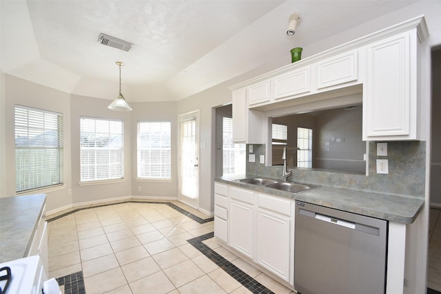 kitchen with plenty of natural light, a raised ceiling, dishwasher, and baseboards