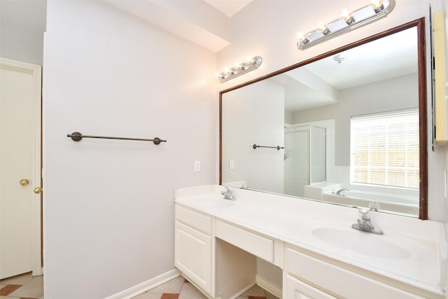 bathroom with a garden tub, a sink, a shower stall, and double vanity