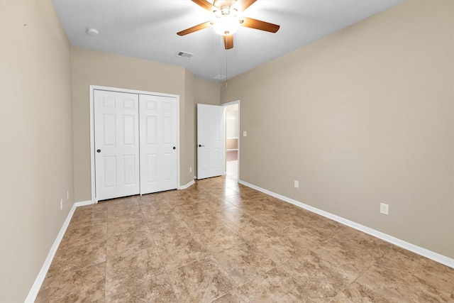 unfurnished bedroom with a closet, visible vents, and baseboards