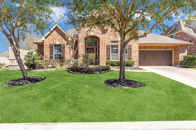 view of front of home featuring driveway, a shingled roof, an attached garage, a front lawn, and brick siding