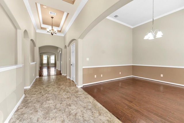 entrance foyer featuring crown molding, wood finished floors, visible vents, and a notable chandelier