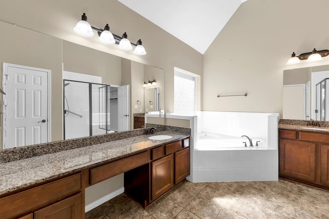 full bath featuring a bath, a stall shower, vaulted ceiling, and a sink