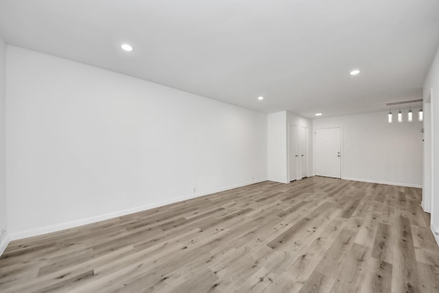 interior space featuring recessed lighting, light wood-style flooring, and baseboards