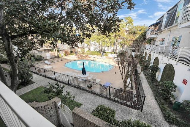 pool with a fenced backyard and a patio